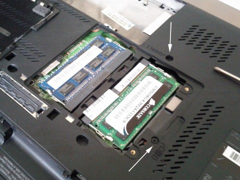 Bottom of Lenovo W520 with memory cover removed showing the two keyboard screws.